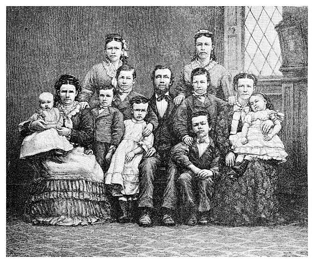 A detailed black and white engraving from the 19th century depicting a large family portrait. The group consists of a father, several women, and nine children of various ages, all dressed in formal Victorian attire. They are posed in a formal indoor setting.