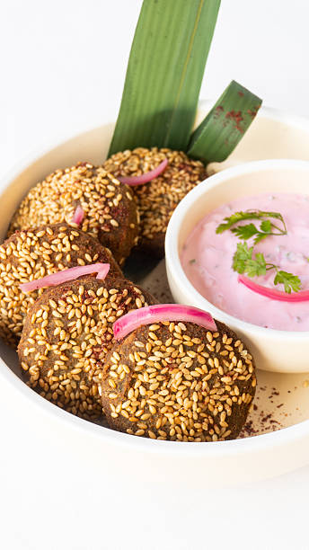 Edamame falafel with toasted sesame and pink radish yoghurt dip served in Middle Eastern gourmet restaurant