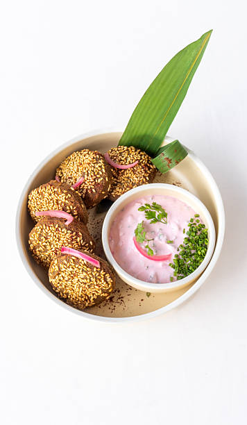 Edamame falafel with toasted sesame and pink radish yoghurt dip served in Middle Eastern gourmet restaurant