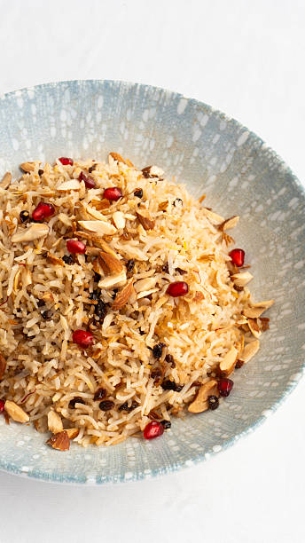 Arabic Chicken Biryani rice dish served with cashew nuts, pomegranate seeds and onions