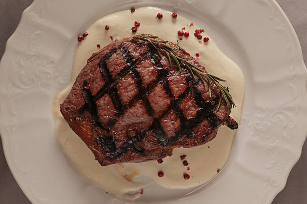 Elegant grilled beef served with sauce and decorative elements