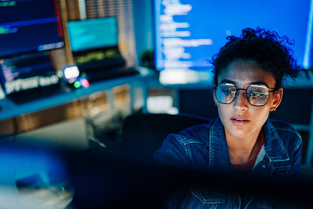 Focused Hispanic female programmer working with code in tech office Focused Hispanic female programmer working with code in tech office machine learning engineer stock pictures, royalty-free photos & images
