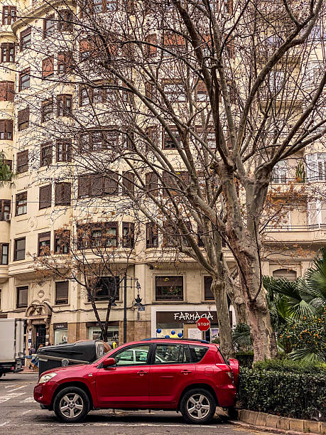 Valencia, Spain - February 13, 2026: Side view of a red Toyota SUV model RAV4 parked in the street. The Japanese manufacturer produced it from 1994 until the present day.