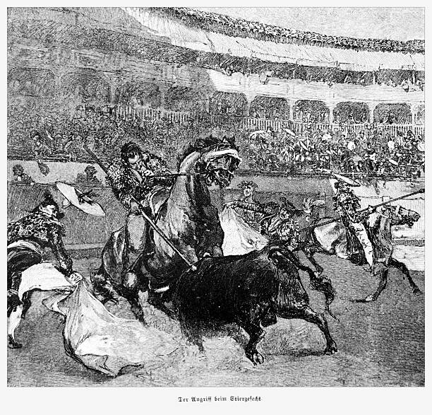 A dramatic black and white illustration of a traditional Spanish bullfight. Picadors on horseback use lances to engage a charging bull in a crowded bullring, while other bullfighters stand ready with capes. The stands are filled with spectators watching the spectacle. Engraved illustration from the 19th century, originally captioned in German 'Der Angriff beim Stiergefecht' (The attack during the bullfight).