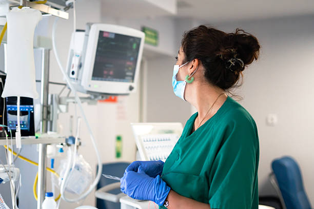 ICU nurse monitoring vital signs