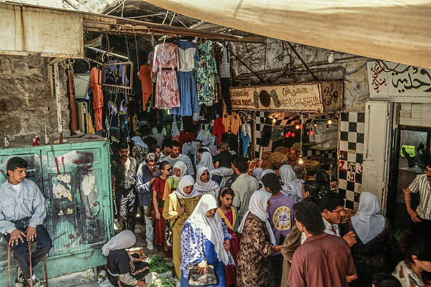 Old Town, Jerusalem, July, 1994.  This is a photo of the narrow streets of Old Town Jerusalem, known as the suk (market).  Centered near Jaffa Gate and David Street, the image shows bustling bazaars.    The streets are filled with both Arab and non-Arab looking people.  This photo was taken during the time that Yitzhak Rabin  was Prime Minister of Israel and it was relatively peaceful on the West Bank and in the Old Town of Jerusalem