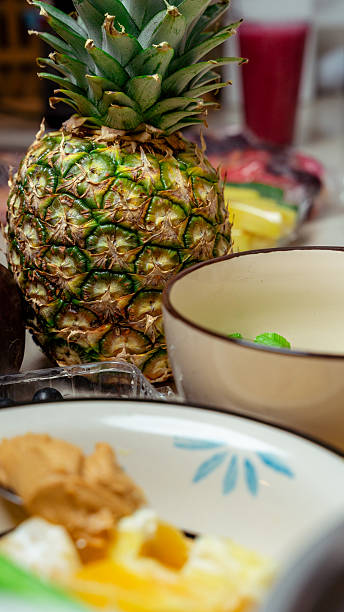 Whole pineapple fruit on kitchen counter preparing healthy breakfast