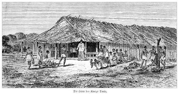 Authentic 19th-century engraving depicting the hut of King Denis Rapontchombo of the Mpongwe people in Gabon, West Africa. The king stands on the porch of his large thatched-roof dwelling while his subjects gather around him, presenting goods and produce. This detailed illustration captures a scene of village life and social hierarchy in Central Africa during the colonial era. Published in a German periodical circa 1880.