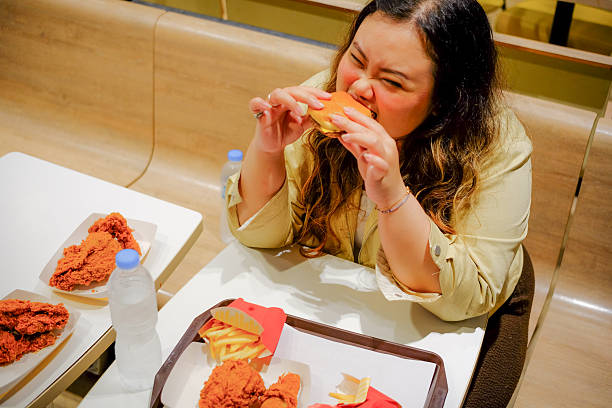 Woman Enjoying Burger and Fried Chicken Meal