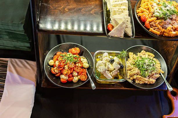 Mediterranean Buffet Spread With Caprese Salad, Marinated Feta and Fusilli Pasta on Display