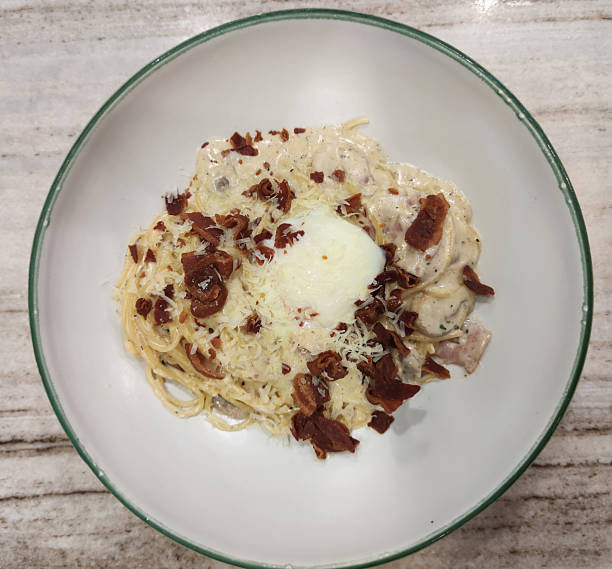 Creamy Italian carbonara pasta with crispy bacon and cheese served in gourmet restaurant style