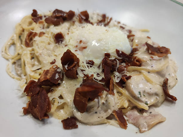 Creamy Italian carbonara pasta with crispy bacon and cheese served in gourmet restaurant style