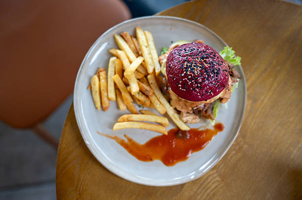 Gourmet Burger with Fries on Wooden Table