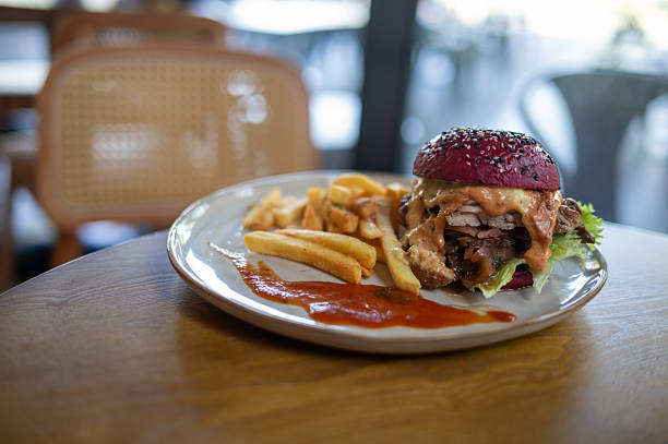 Gourmet Burger with Fries on Wooden Table