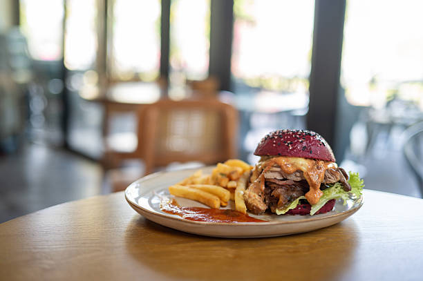 Gourmet Burger with Fries on Wooden Table