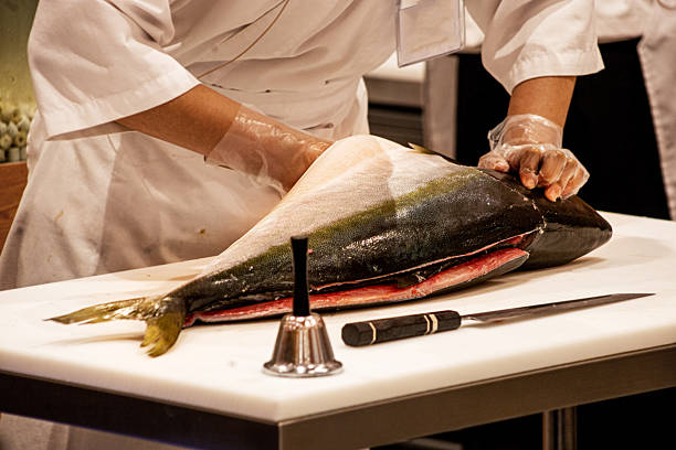 Chef show sliced very huge blue fin tuna or Otoro to the guest