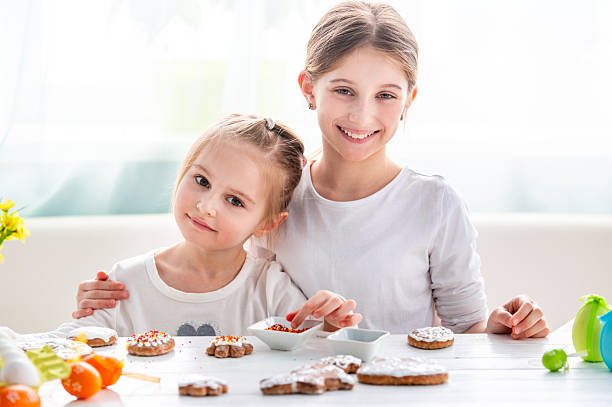 Two Little Girls Decorating Gingerbread Cookies