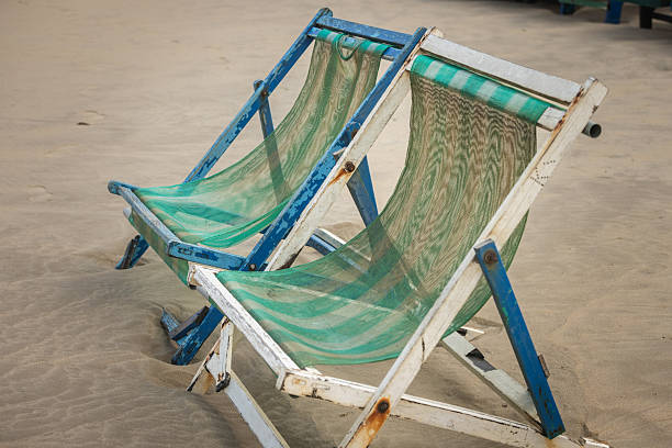 Two long beach chairs stands on the beach.My Khe Beach - Vietnam.