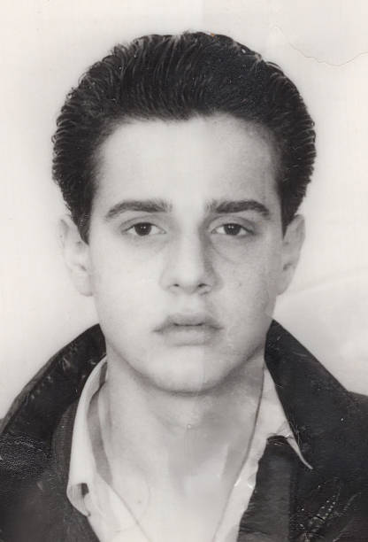 image taken in the 1970s: headshot of a young man looking at the camera