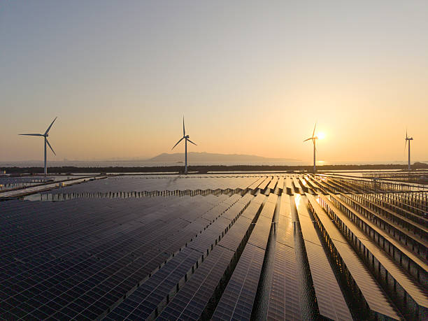 A tranquil landscape painting showing solar panels and wind turbines under the rising sun, presenting renewable energy, with a warm visual style, and the potential for content related to environmental or technological themes.