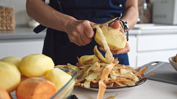 Woman Is Peeling Potatoes