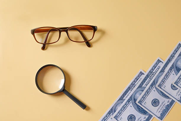 US dollars money bills and magnifying glass,business theme.