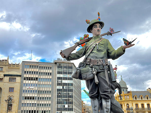 Valencia, Comunidad Valenciana, Spain - March 14, 2026: Monumental Falla sculpture representing Charlie Chaplin dressed as a soldier, holding a butterfly, symbolizing peace during the traditional Fallas de Valencia festival in Spain