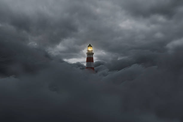 3D rendering of an illuminated lighthouse over darken fluffy clouds