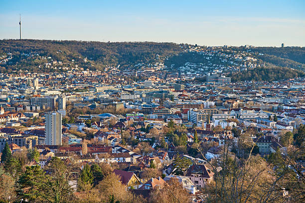 Stuttgart city skyline at blue hour – panoramic night view of Stuttgart, Germany with illuminated downtown, valley cityscape and TV towers on surrounding hills