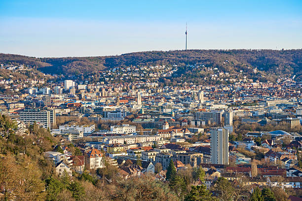 Stuttgart city skyline at blue hour – panoramic night view of Stuttgart, Germany with illuminated downtown, valley cityscape and TV towers on surrounding hills
