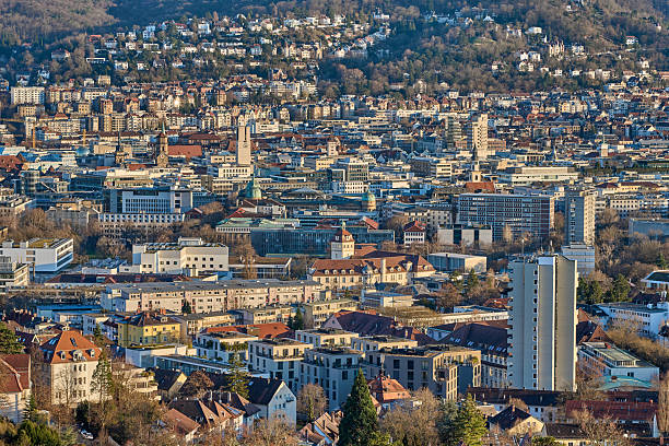 Stuttgart city skyline at blue hour – panoramic night view of Stuttgart, Germany with illuminated downtown, valley cityscape and TV towers on surrounding hills