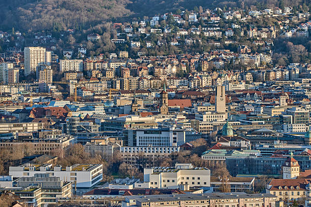 Stuttgart city skyline at blue hour – panoramic night view of Stuttgart, Germany with illuminated downtown, valley cityscape and TV towers on surrounding hills