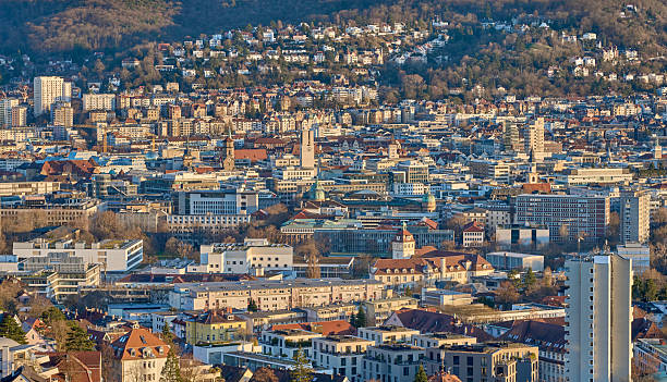 Stuttgart city skyline at blue hour – panoramic night view of Stuttgart, Germany with illuminated downtown, valley cityscape and TV towers on surrounding hills