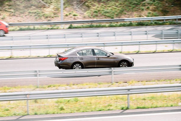 Torrelavega, Spain - 13 March, 2026: A Infiniti Q50 in motion on a highway