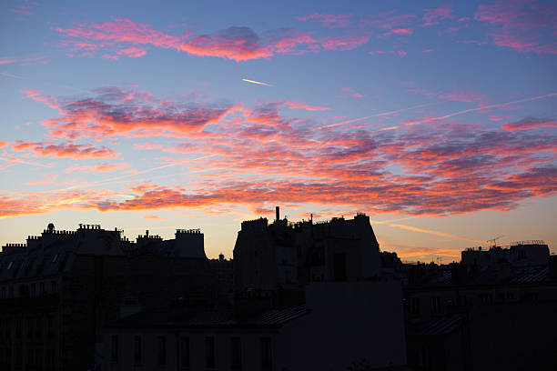 Paris, France: Skyline of residential buildings at a pink sunrise, 11th arrondissement. Shot taken from Rue Oberkampf.