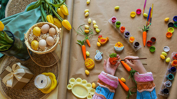 Creative Easter egg and cookie decorating with colorful paints and brushes