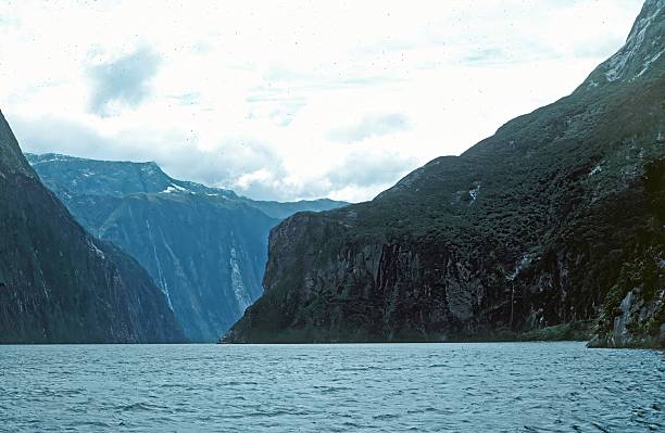 view along the sound under a cloudy skyMilford Sound, Fiordland National Park, New Zealand.  January