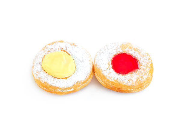Donuts with icing sugar and  strawberry jam isolated on white background