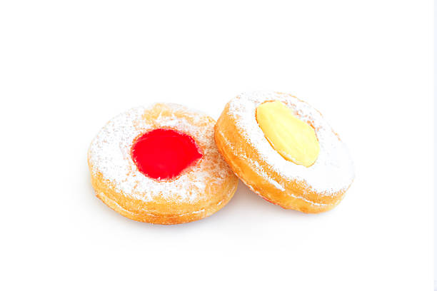 Donuts with icing sugar and  strawberry jam isolated on white background
