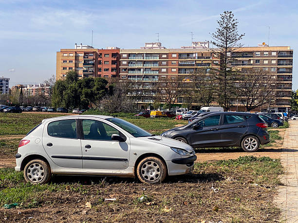 Valencia, Spain - March 11, 2026: A white Peugeot car model 206 hatchback parked on a dirt ground outdoors. The French manufacturer produced it in France from 1998 until 2012.