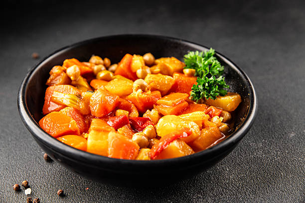 Stewed vegetables ragout potatoe, carrot, chickpea, onion, zucchini, pumpkin tasty snack fresh gourmet food background on the table rustic food top view copy space keto and paleo diet vegetarian and vegan foodmarketing concept photo