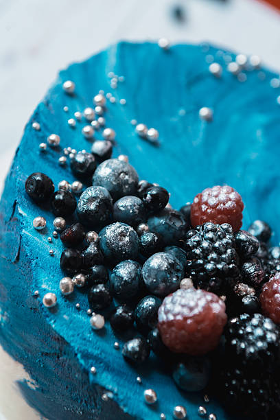 Blue buttercream cake with berries side macro