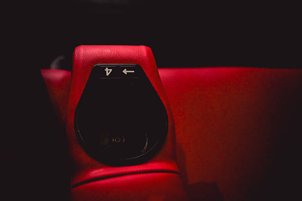 Empty red cinema seat armrest with number four and an empty cup holder