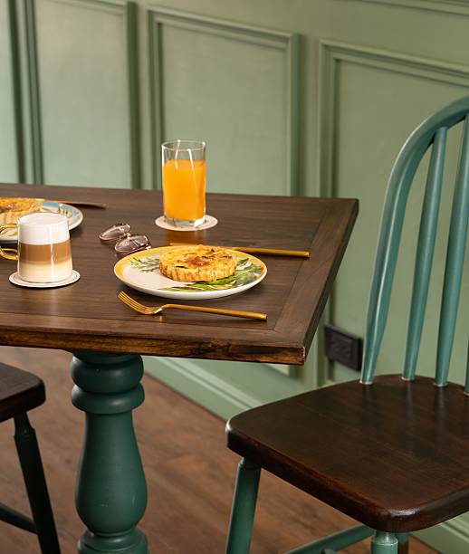 Elegant breakfast table setup with juice, coffe and sandwich