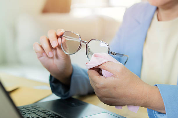 Dust, cloth and glasses in hands for cleaning lens and vision with clear glass from optometry. Wipe, frame and easy care for spectacles with silk fabric and maintenance of eyewear for person eyesight