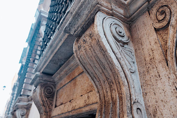 Close view of ornamental design on old building with architectural elements in sunlight