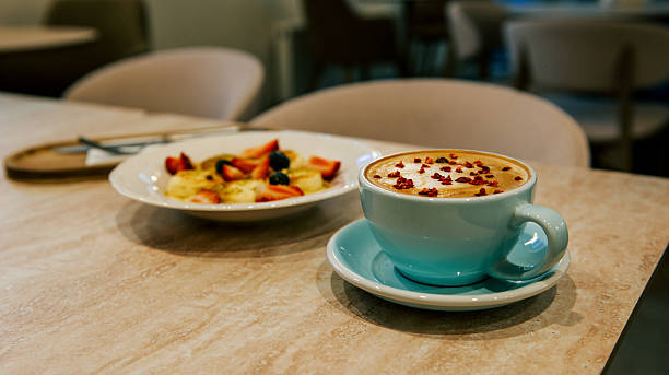 Delicious breakfast with coffee and fresh fruit plate in a cozy caf?