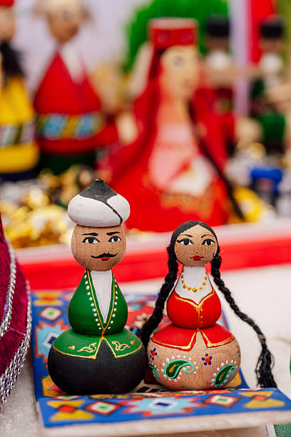 Pair Of Handpainted Wooden Dolls On Colorful Mat, Folk Souvenir Scene With Braided Hair Details, Painted Faces