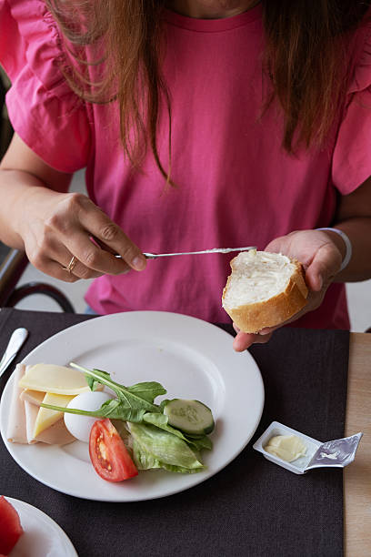Enjoying a delightful breakfast with fresh bread, salad, and cheese at a cozy cafe on a sunny morning