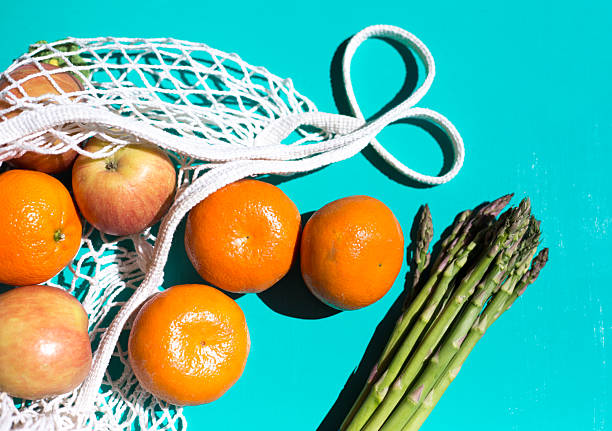 Net Shopping Bag, Mandarins  Apples Asparagus, Sunny Turquoise Background